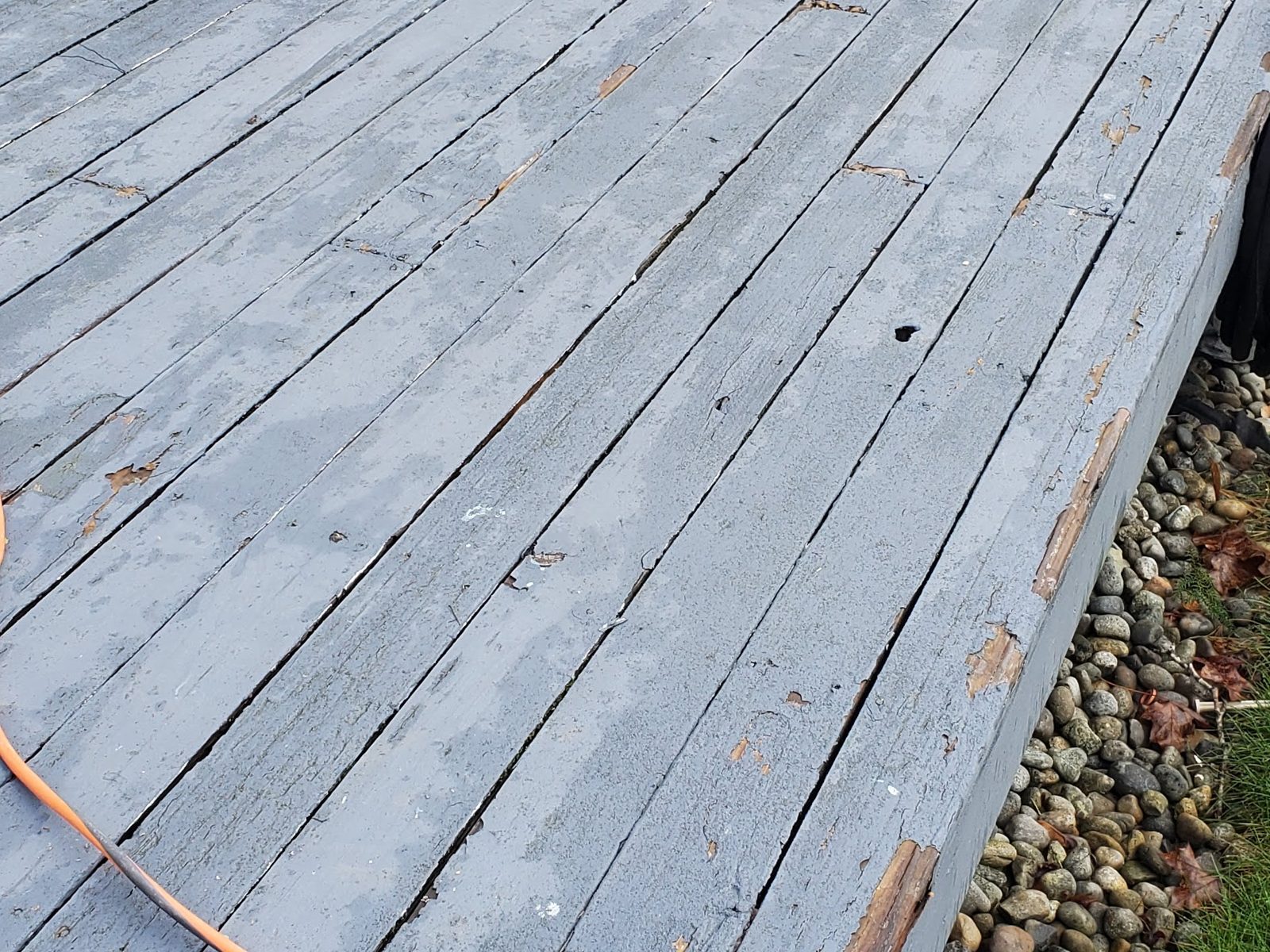 Rotted, weathered wood deck before replacement