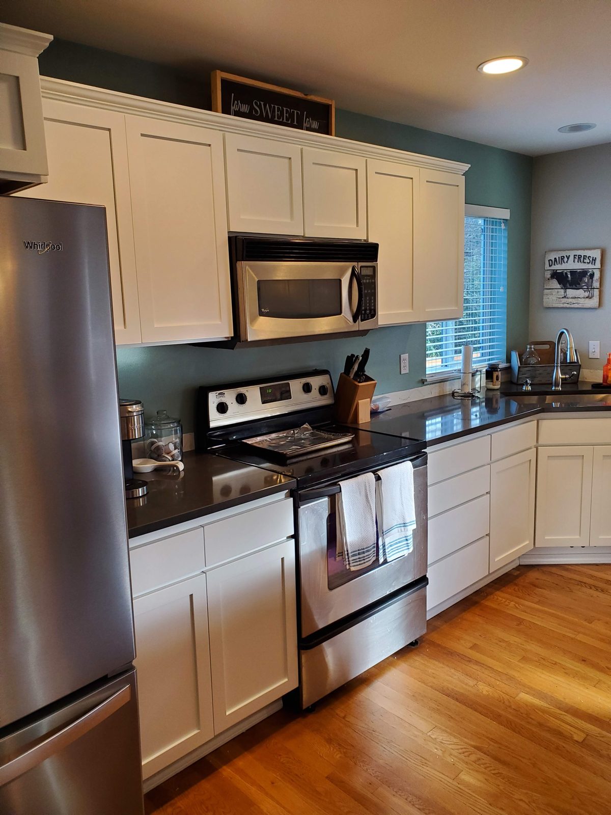 Same kitchen with cabinets professionally painted white