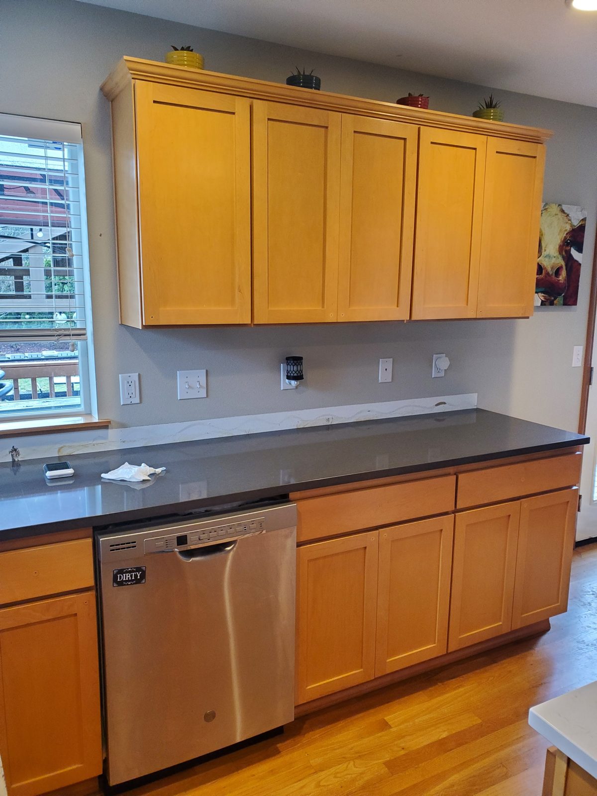 Kitchen with dated orange-oak cabinets