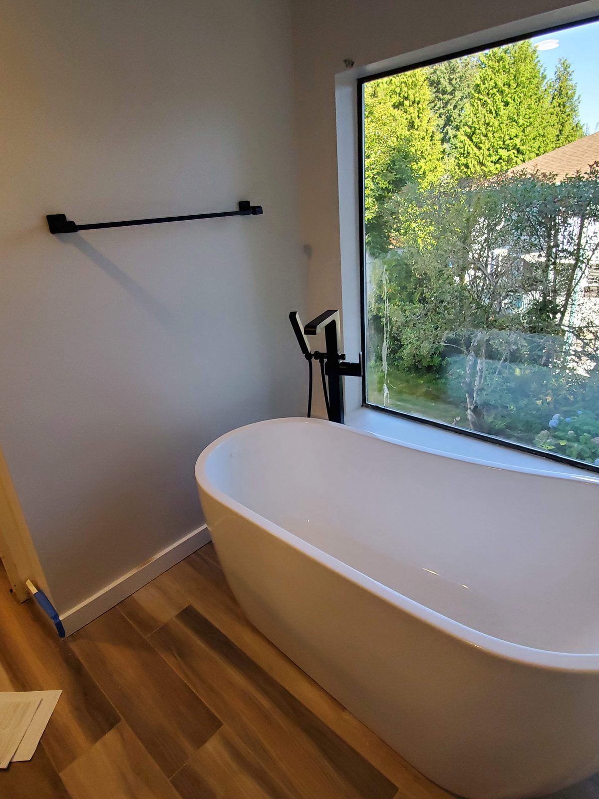Renovated bathroom with freestanding tub and black fixtures